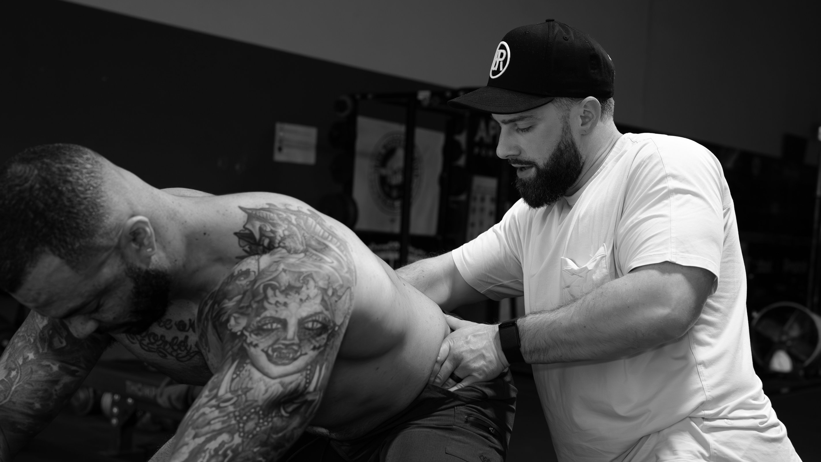 Athlete experiencing low back pain during barbell squat assessed by Dublin sports PT