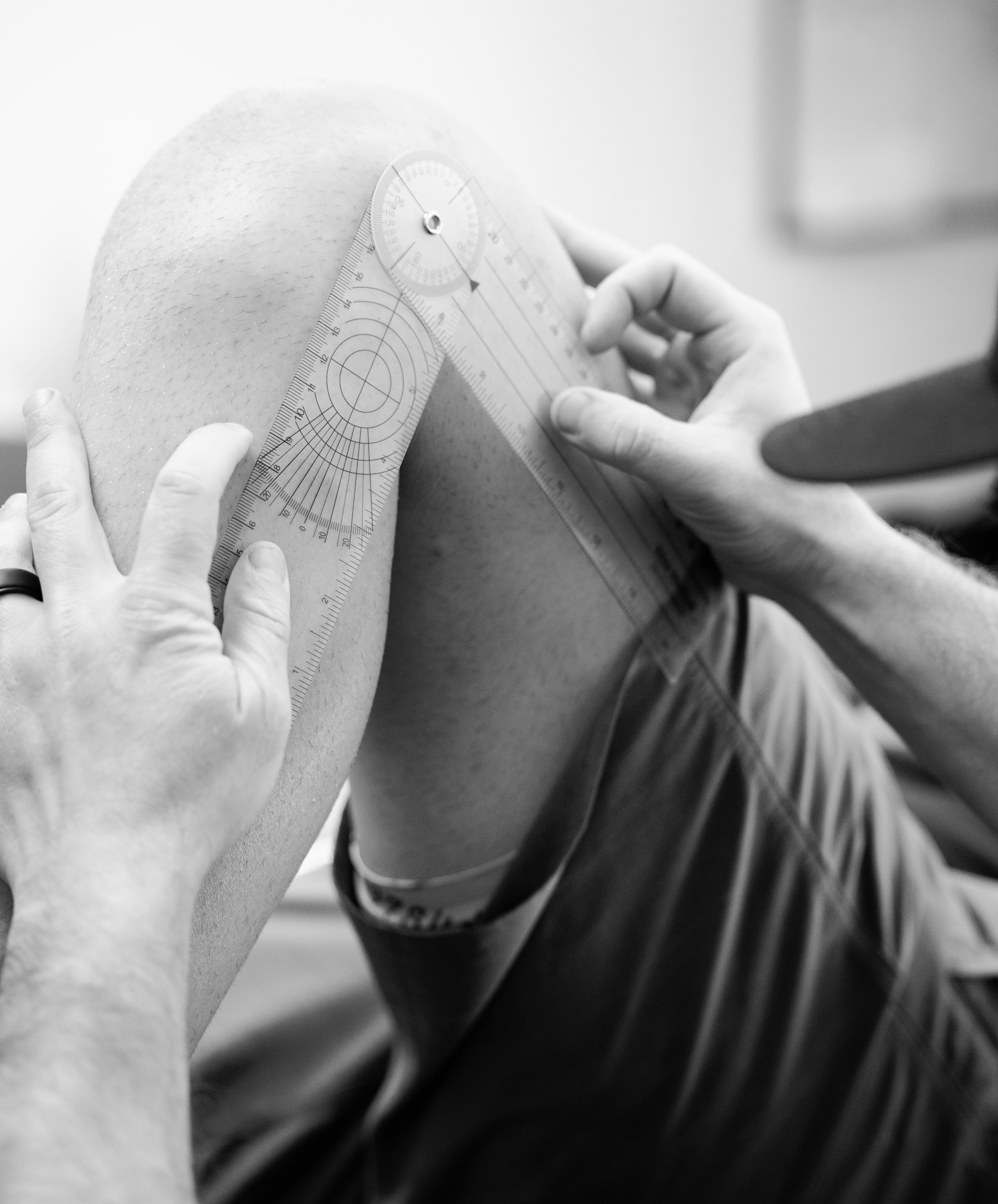 Athlete performing ACL rehab at Bax Performance and Rehab in Pleasanton, CA using neuromuscular stimulation and functional training for knee recovery.