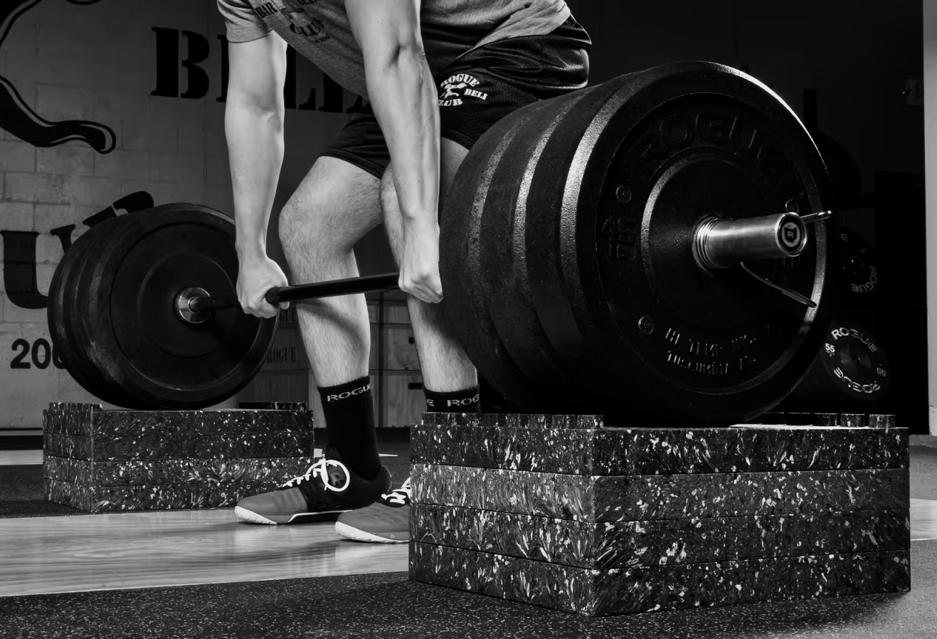 Athlete performing a modified range deadlift at Bax Performance and Rehab in Pleasanton, CA to train safely while managing pain and improving strength.