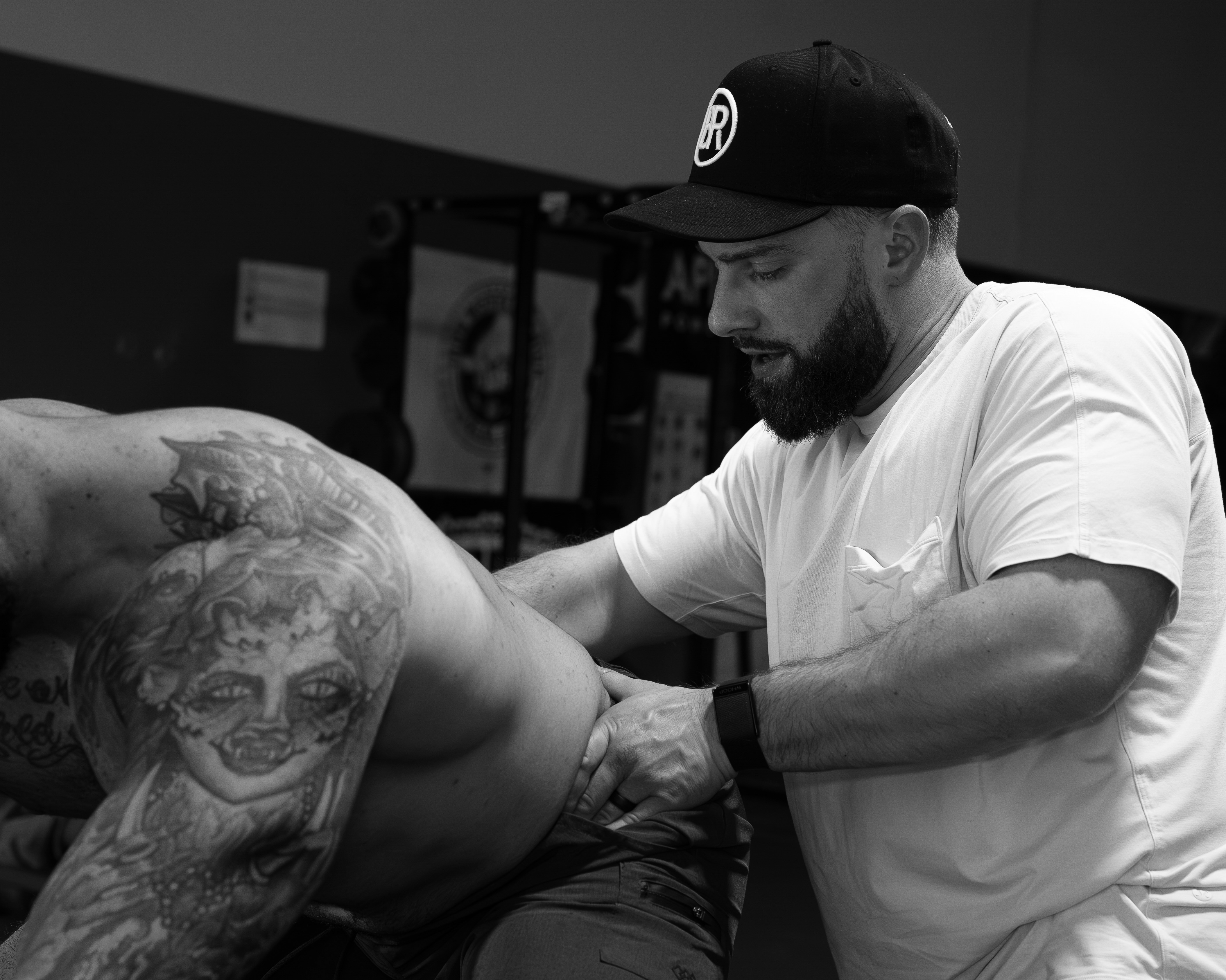 Athlete performing band-assisted thoracic extension exercise at Bax Performance and Rehab in Pleasanton, CA to improve spinal mobility after manual therapy.