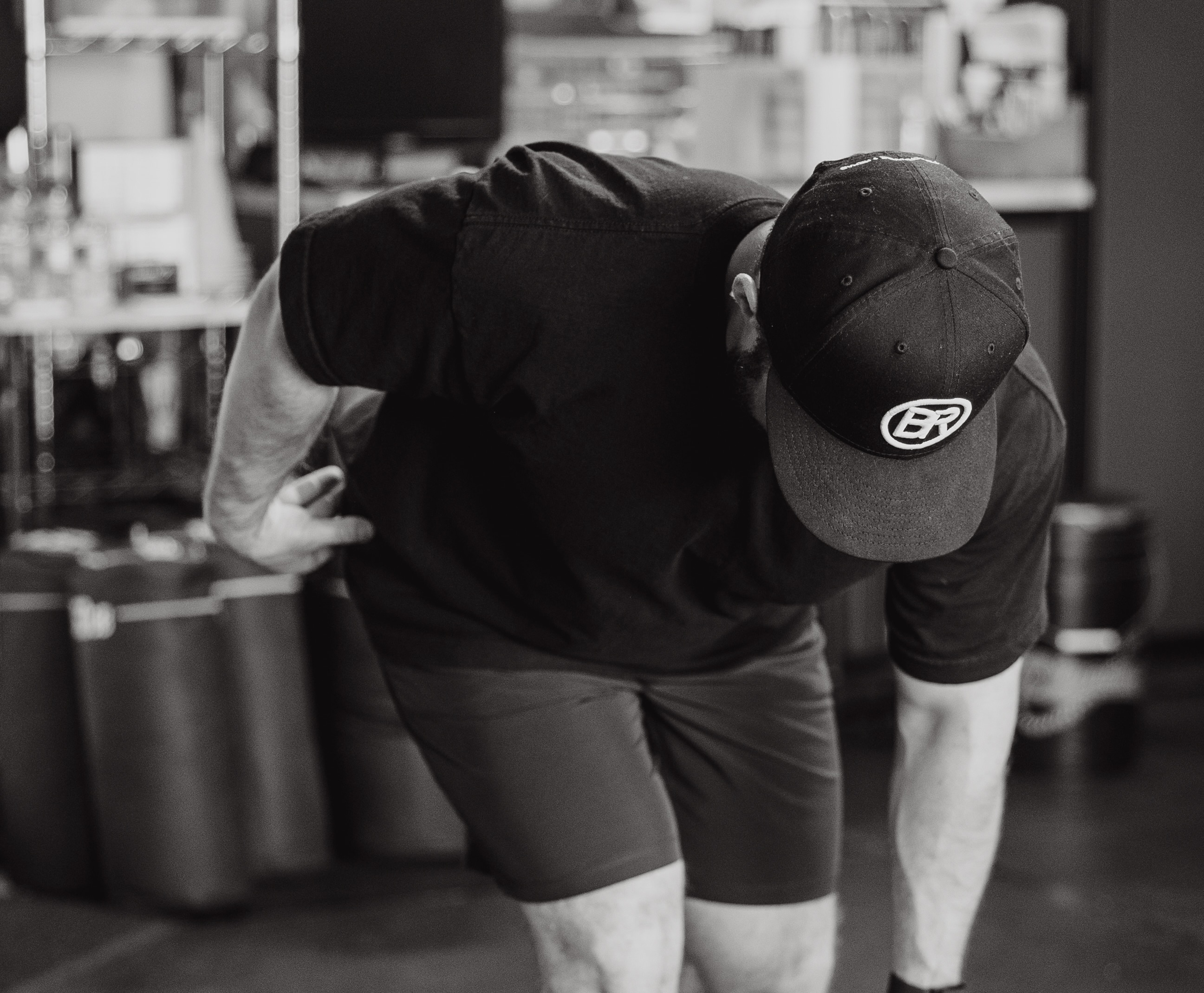 Athlete practicing hip hinge drill with medicine ball at Bax Performance and Rehab in Pleasanton, CA to improve movement mechanics and reduce low back pain.