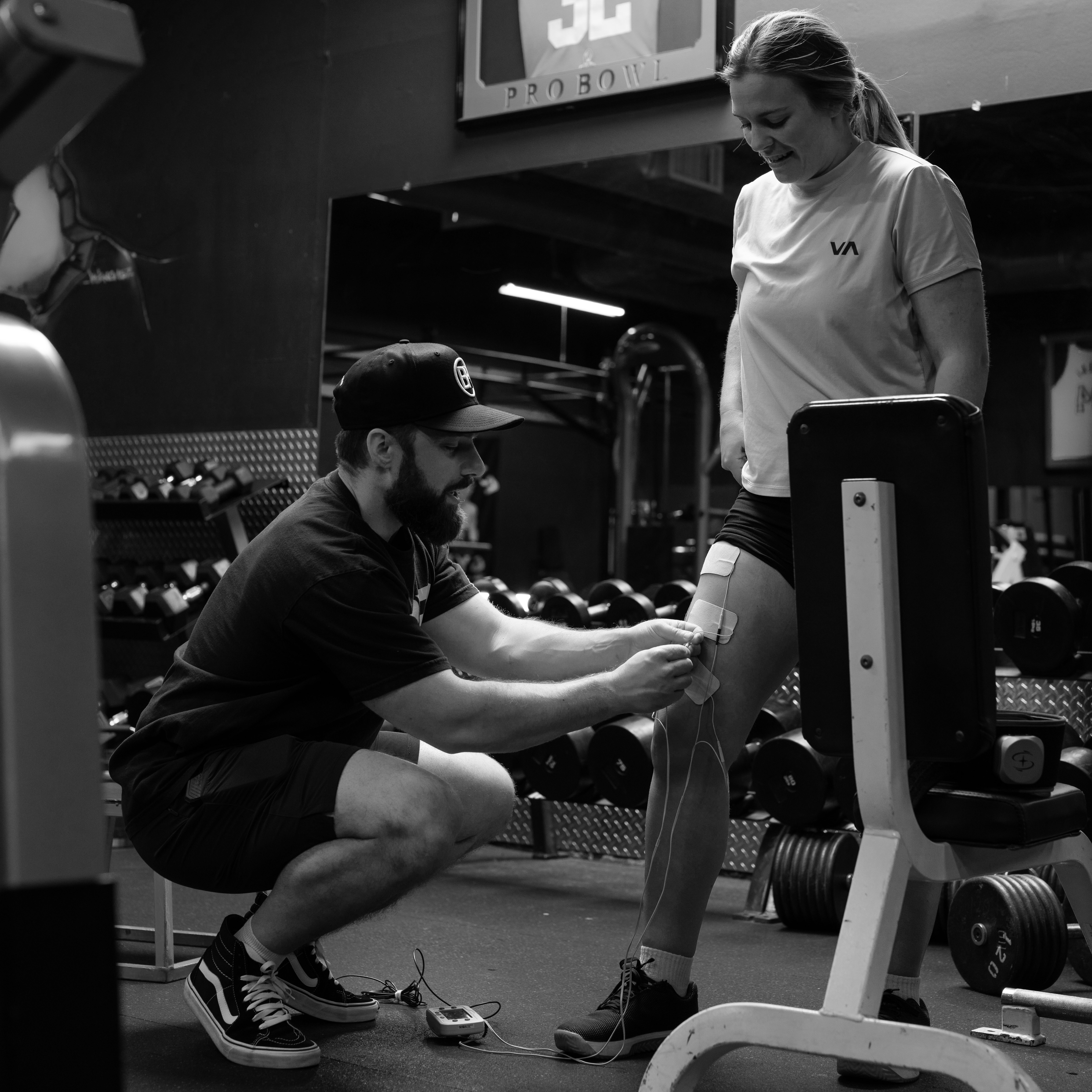 Physical therapist guiding athlete through modified rehab exercise at Bax Performance and Rehab in Pleasanton, CA to reduce pain and restore full movement.