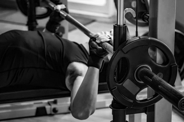 Athlete performing lacrosse ball shoulder mobility work at Bax Performance and Rehab in Pleasanton, CA to reduce shoulder pain and improve bench press mechanics.